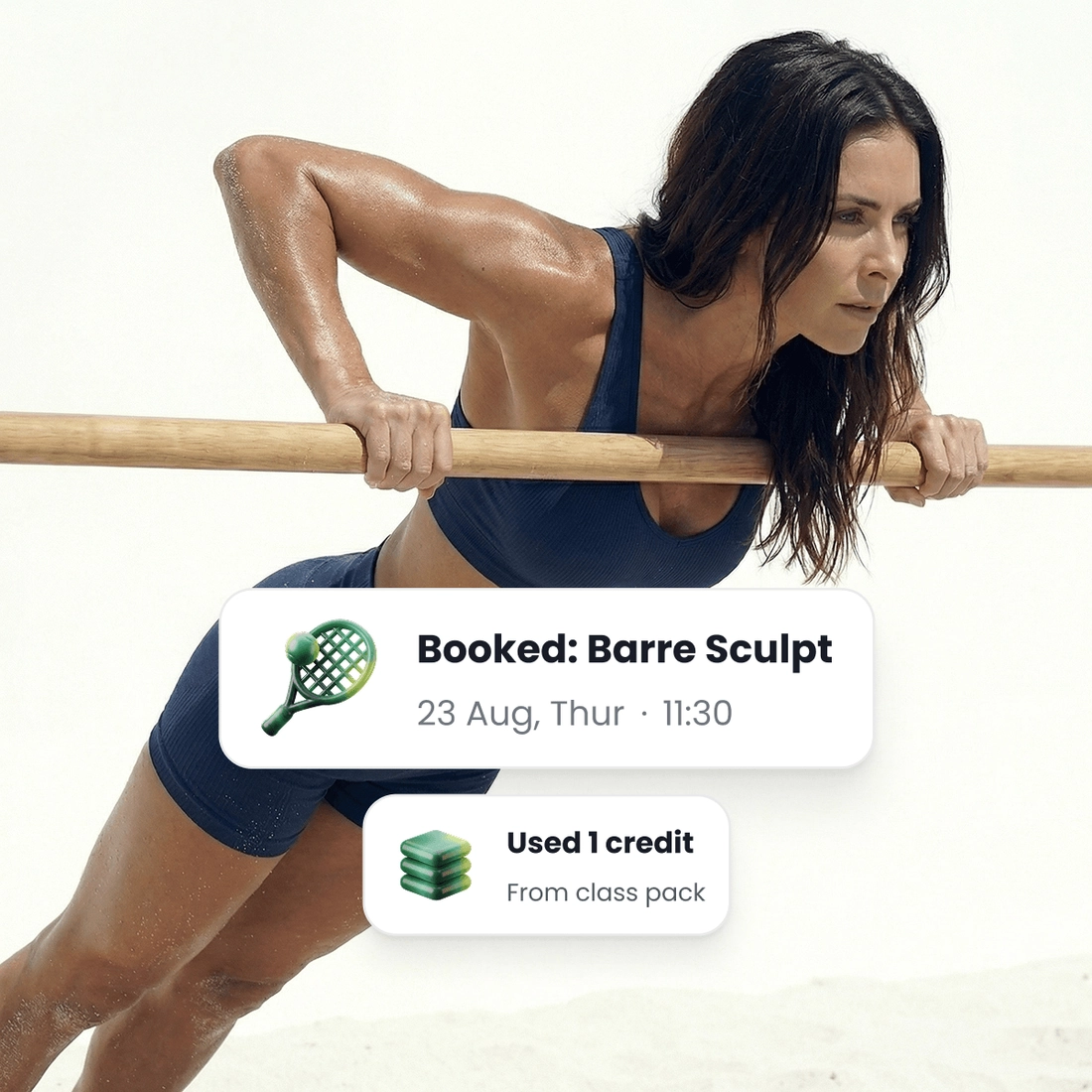 A woman leaning on the barre, beside the class she just booked and the credit it took off her pack.