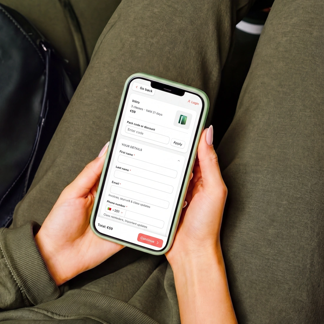 A customer part way through checkout on their phone, showing a three class pack, a field for a code, the details form and the total.